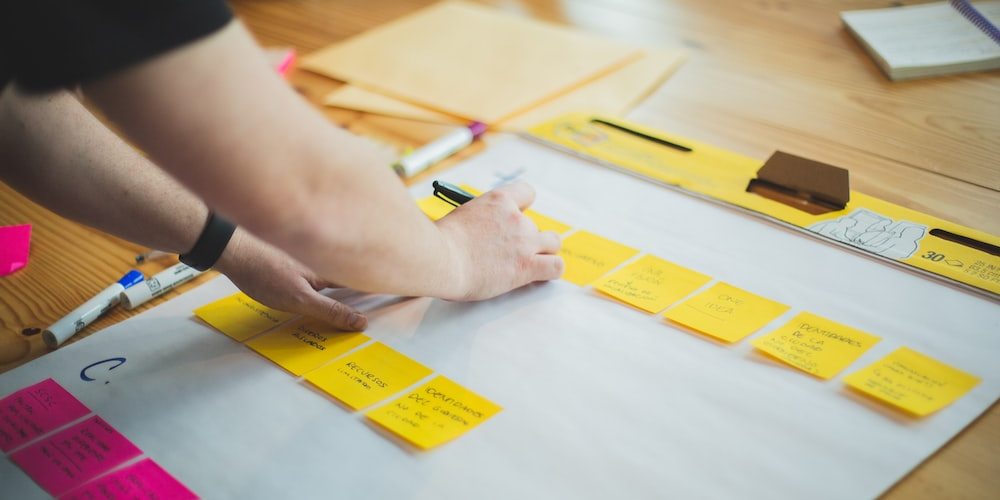 A person using sticky notes for project planning